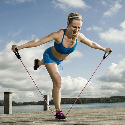 femme debout sur un pied ce tien sur son elastique en equilibre sur une jambe